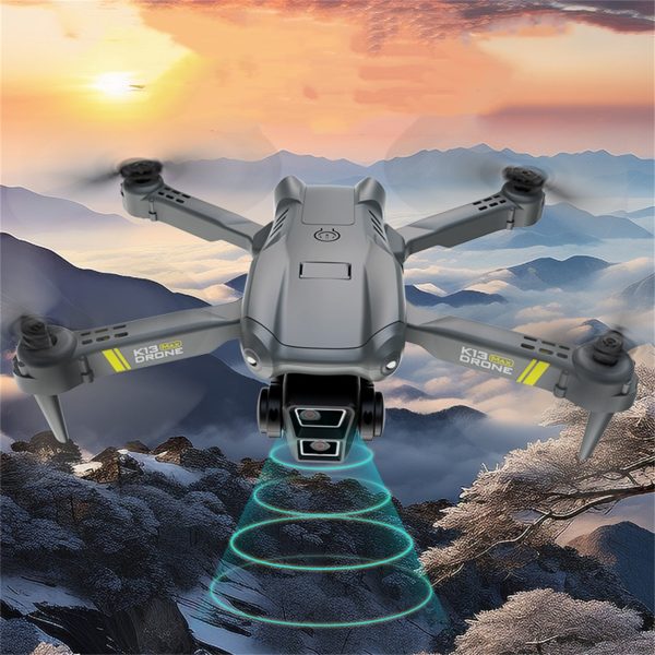 TheK13 Smart Camera Drone With 2 Batteries Features Real-time Image Transmission From A Single Camera. It Has One-click Touch And Landing Functions. This Is A Foldable Remote-controlled Drone Toy, Ma